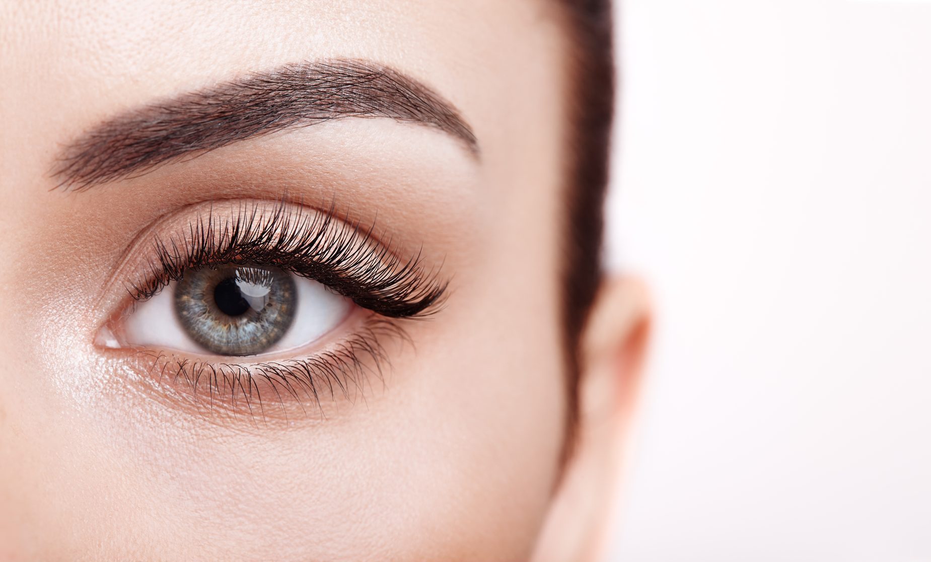 Female Eye with Extreme Long False Eyelashes. Eyelash Extensions. Makeup, Cosmetics, Beauty. Close up, Macro